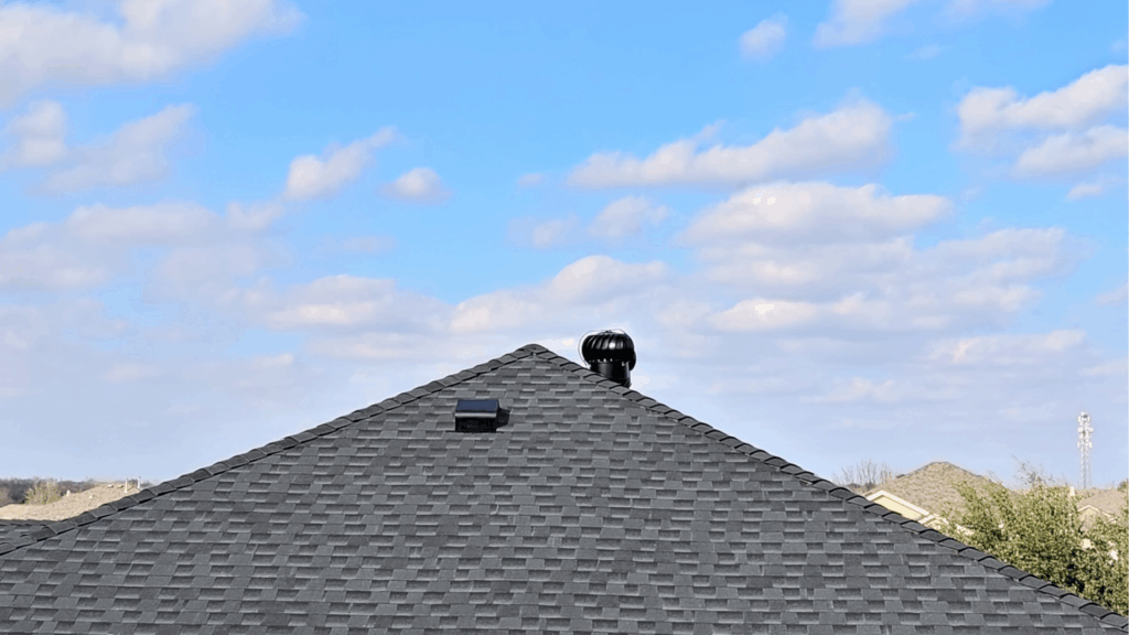 Finished roof replacement featuring charcoal colored class 4 impact resistant shingles provided by GAF
