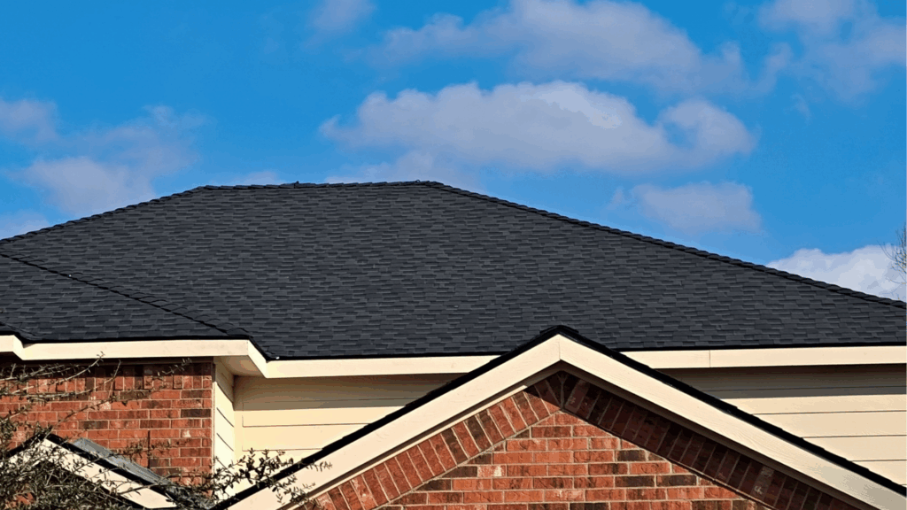 Finished roof replacement featuring charcoal colored class 4 impact resistant shingles provided by GAF
