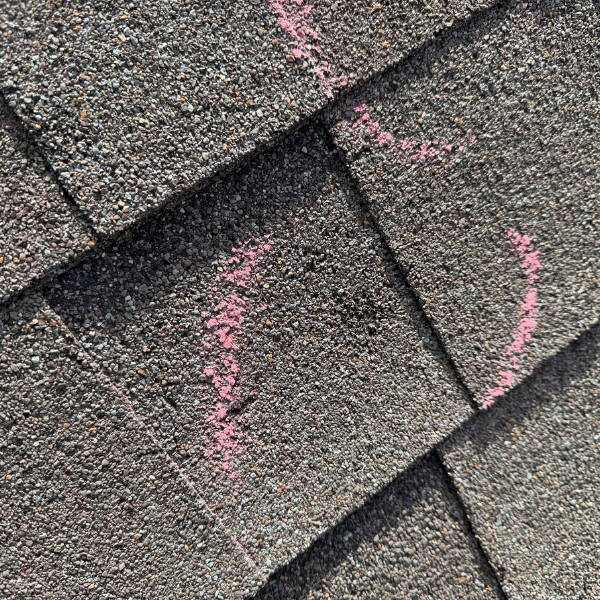 Close up of hail damage impact point marked with pink chalk