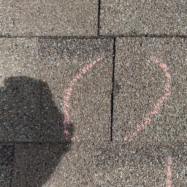 Close up of hail damage impact point marked with pink chalk