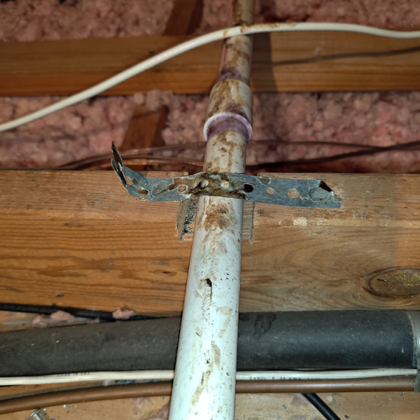 Close up of rodent activity known as rat rubs on PVC pipe in the attic